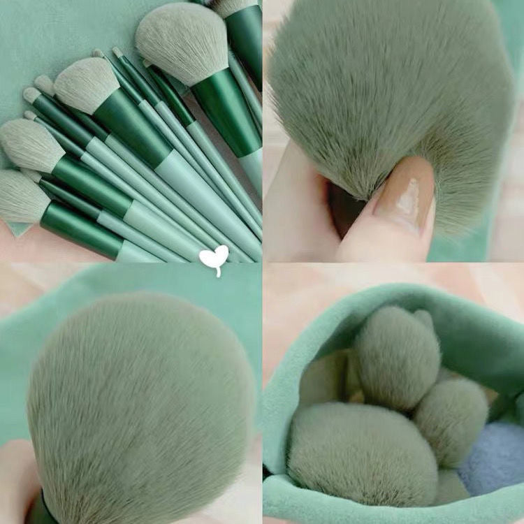 a close up of a person holding a bunch of makeup brushes