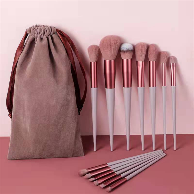 a bag of makeup brushes next to a set of brushes